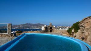 einen großen Pool mit Blick auf das Wasser in der Unterkunft Nalu Villa in Ornos