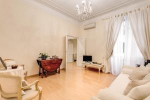 a living room with a couch and a table at RHH Rome Holiday Home in Rome