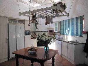 a kitchen with a table with a bowl of fruit on it at 3 Dolphins in Britannia Bay
