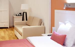 Postel nebo postele na pokoji v ubytování Rudolfo Hotel