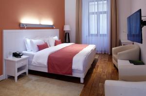 Postel nebo postele na pokoji v ubytování Rudolfo Hotel