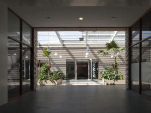 an empty hallway in a building with potted plants at easyHotel Amsterdam Zaandam in Zaandam