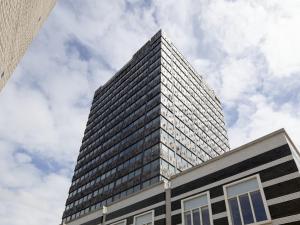 a tall building with a sky in the background at easyHotel Amsterdam Zaandam in Zaandam