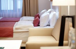 Postel nebo postele na pokoji v ubytování Rudolfo Hotel