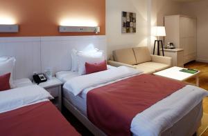 Postel nebo postele na pokoji v ubytování Rudolfo Hotel