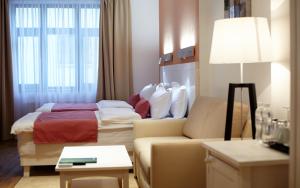 Postel nebo postele na pokoji v ubytování Rudolfo Hotel