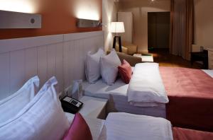 Postel nebo postele na pokoji v ubytování Rudolfo Hotel