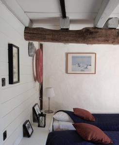 a bedroom with two beds and a picture on the wall at La Blanchisserie in Le Puy-Saint-Bonnet