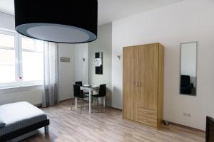 a bedroom with a bed and a table and a cabinet at City Apartment Aurich - Ostfriesland in Aurich