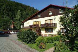 a large building with a balcony on the side of it at Pokoje Beata in Wisła