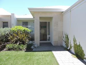 a house with a walkway in front of a yard at Contemporary Cove - Quindalup in Quindalup
