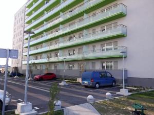 un grand bâtiment avec des voitures garées dans un parking dans l'établissement Apartment Ali, à Zagreb