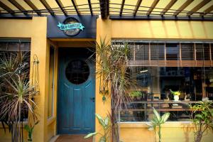 a blue door of a restaurant with a sign on it at Old Capital Bike Inn - SHA Certified in Bangkok