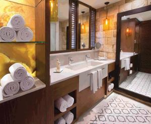 a bathroom with two sinks and a large mirror at Hard Rock Hotel Riviera Maya- Heaven Section (Adults Only) All Inclusive in Puerto Aventuras