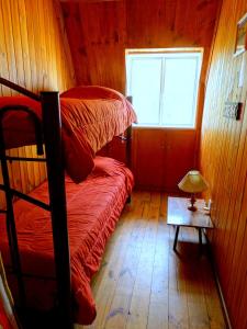 a bedroom with two bunk beds and a window at La Casa del Tata in Potrerillos