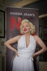 a woman in a white dress standing in front of a sign at The Sandringham Court Hotel & Apartment Welcoming Large and Small Groups for 15 years in Blackpool