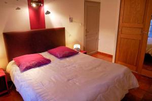 a bedroom with a large bed with two pillows on it at Pres Bataillers in Malaucène