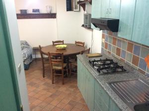 a kitchen with a table and a dining room at Villino with Garden in Tropea