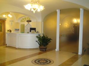 a lobby with a counter and a potted plant at Hotel Villa Franca in Ischia