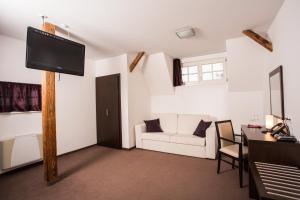 a living room with a tv on a wooden pole at Vila Monet in Laško