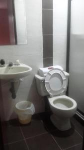 a bathroom with a toilet and a sink at Hotel Center in Ibagué