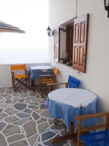 a room with two tables and chairs in a room at Blue Sky in Ios Chora