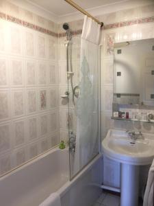 a bathroom with a shower and a sink at Glenspean Lodge Hotel in Roybridge