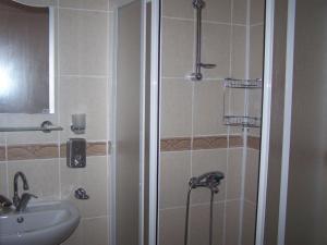 a bathroom with a shower and a sink at Golden Beach Hotel in Didim +40 photos