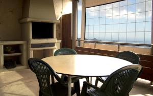 a table and chairs in a room with a large window at Albergue Montes de Anaga in El Bailadero