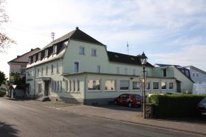 a large white building on the side of a street at Hotel St. Hubertus in Wallmerod