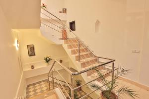 a staircase in a house with plants at Riad Diamant Blanc in Essaouira