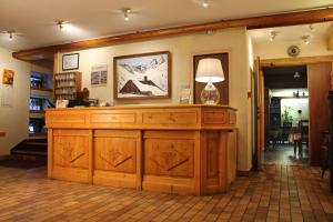 a room with a large wooden cabinet with a lamp on it at Hôtel du Crêt Rond in Valloire