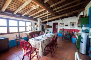 a dining room with a table and red chairs at Herdade das Pintas in Monforte