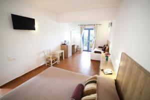 a living room with a couch and a tv in it at Elpida Village in Istro