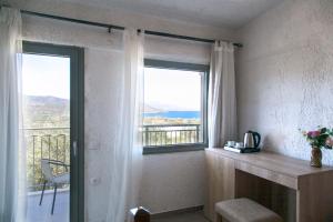 a room with a window with a view of a balcony at Elpida Village in Istro