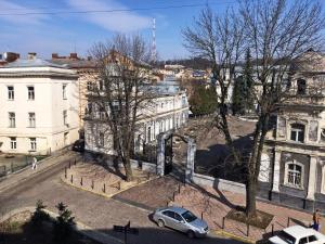 a car parked on a street in front of buildings at New York Hostel in Lviv