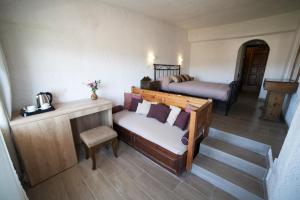 a room with a couch and a bed in a room at Elpida Village in Istro