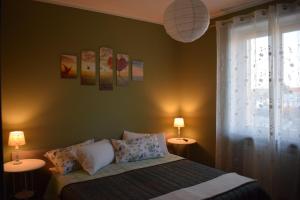 a bedroom with a bed with two lamps and a window at Bene&Breakfast in Bene Vagienna +96 photos