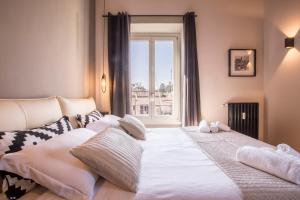 
a hotel room with a bed and a window at EVE Penthouse Colosseo in Rome
