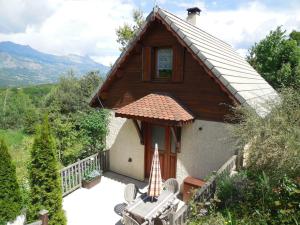 a small house with a porch and a patio at Les Gîtes de Galinette in La Bâtie-Vieille