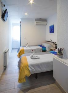 Postel nebo postele na pokoji v ubytování Hostal Pardo