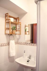 a bathroom with a sink and a mirror at Lilas' Private Accommodation in Vila do Bispo +34 photos
