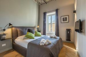 
a bedroom with a large bed and a large window at EVE Penthouse Colosseo in Rome
