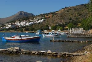 three boats are docked in a body of water at Athina Villas in Elounda