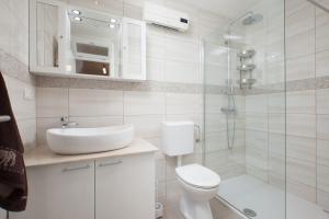 a bathroom with a toilet and a sink and a shower at Apartment Kairos in Podgora +34 photos