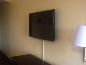 a flat screen tv hanging on a wall at Americas Best Value Inn Waco - Franklin Avenue in Waco