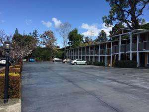 un aparcamiento vacío frente a un edificio en Oak Motel, en Palo Alto