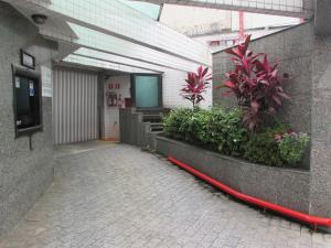 a hallway of a building with a red hose at Pleasant Place Hotel in Sao Paulo