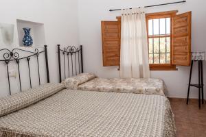 A bed or beds in a room at Cortijo La Molina de Cabo de Gata