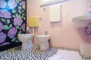 a bathroom with a toilet and a sink at Ariston Vacanze in Marina di Ravenna +19 photos